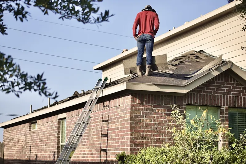 Professional roofer working on a residential roof in Derby